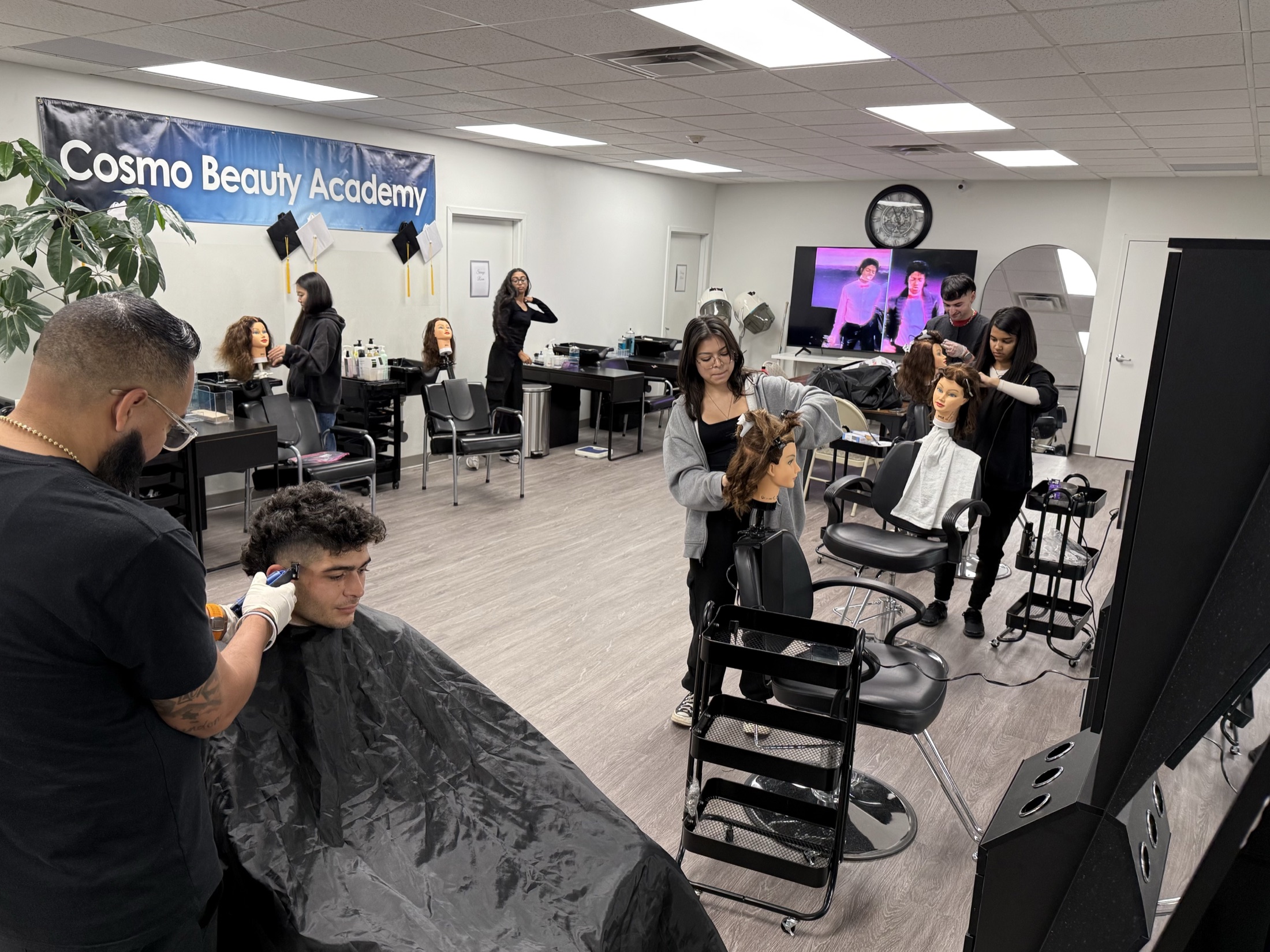 Cosmetology and barbering students training in the classroom at Cosmo Beauty Academy in Saddle Brook, New Jersey