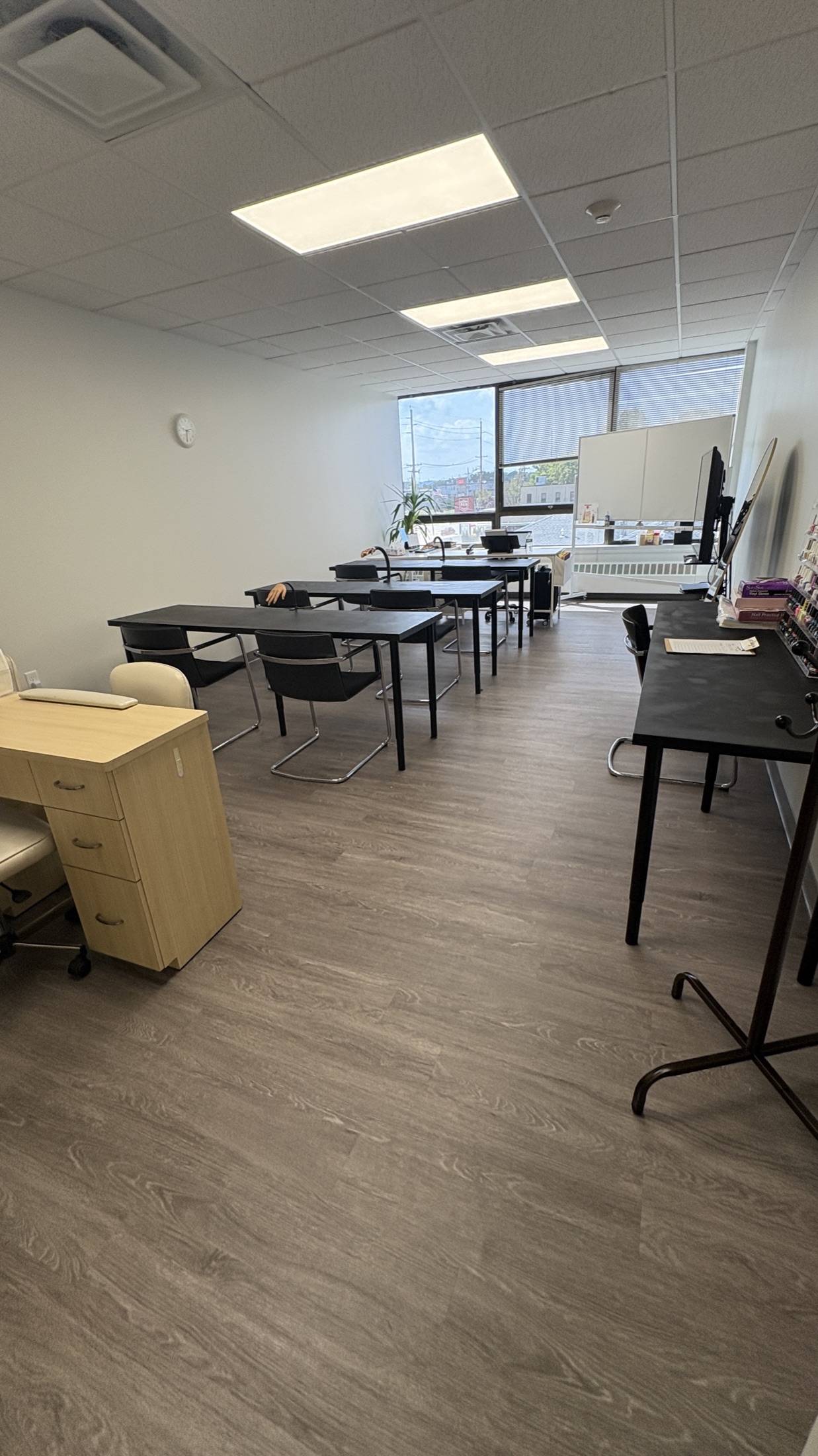 Nail technology classroom and student workstations at Cosmo Beauty Academy in Saddle Brook, New Jersey